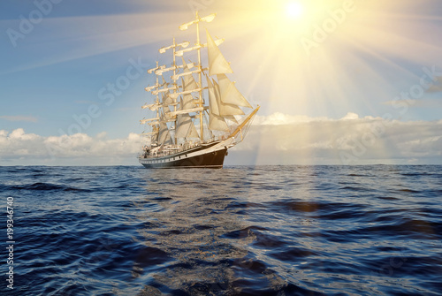 Sailing ship and sun rays. Sailing. Yachting