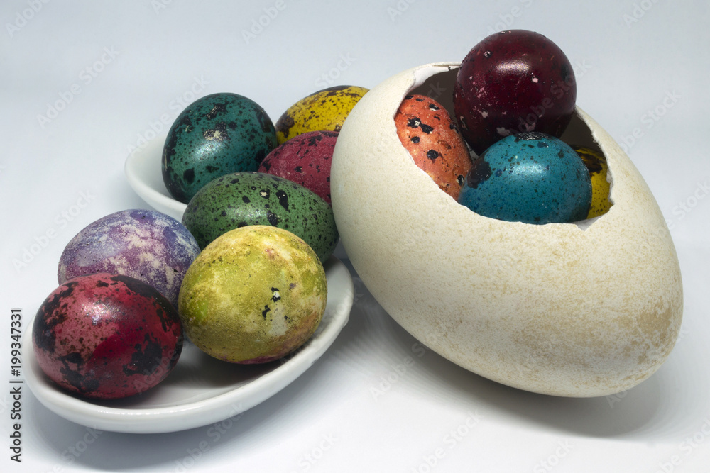 Theme Esther. Painted quail eggs in a duck shell and in small saucers. Close-up. Theme Esther. Painted quail eggs in a duck shell and in small saucers. Close-up.
