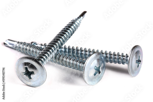three metal screws isolated on white background closeup