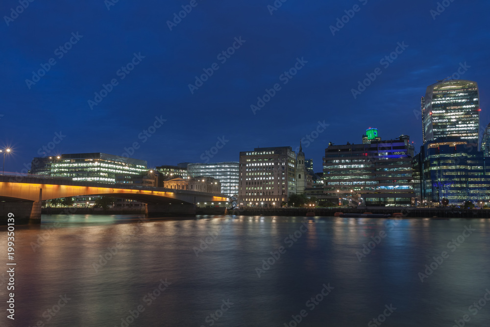Thames embankment, London Bridge and london skyscrapers in City of London in the night. Thames embankment, London Bridge and london skyscrapers in City of London in the night.
