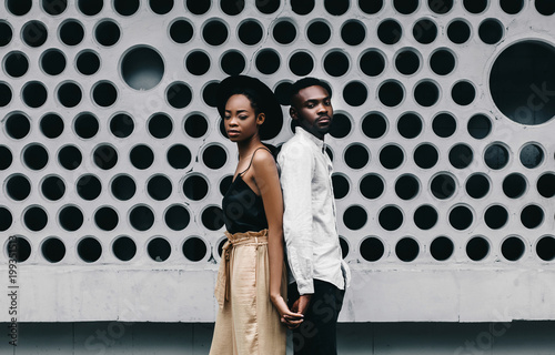 Lovely african newlyweds softly holding each other and smilling.