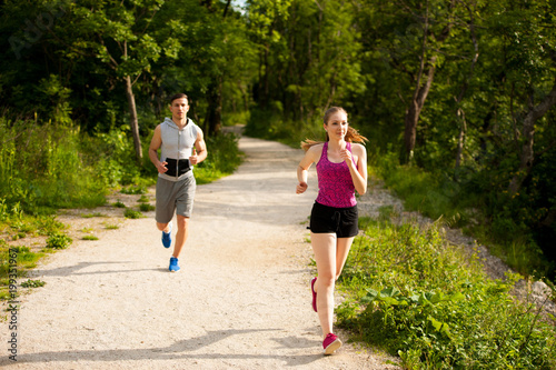 Active young couple running in the park