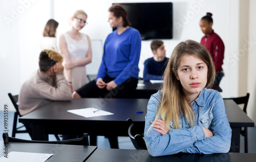 Girl student being shy among classmates