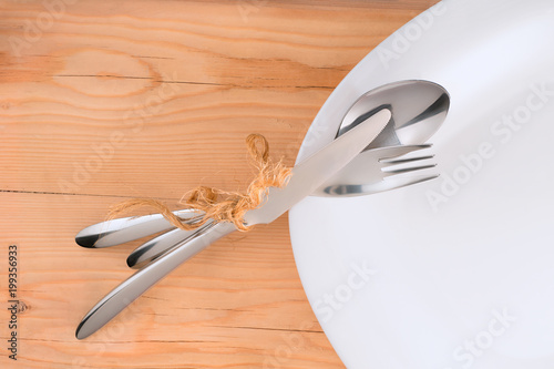 Place setting on wooden table.