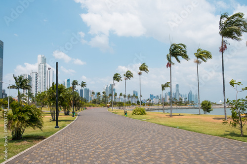 Sidewalk at public park with city skyline at coast promenade in Panama City - photo