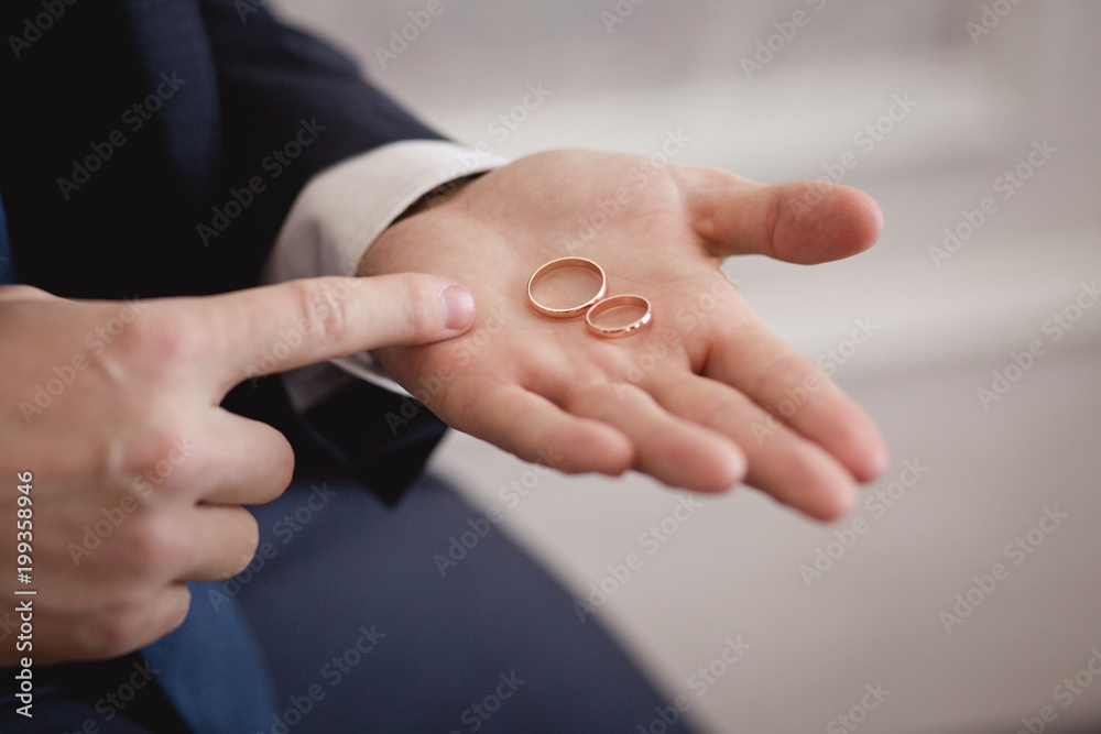 Wedding rings on Groom's hands. Preparing to wedding day Wedding rings on Groom's hands. Preparing to wedding day
