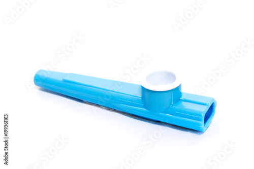 Childrens blue plastic kazoo on a white background photo