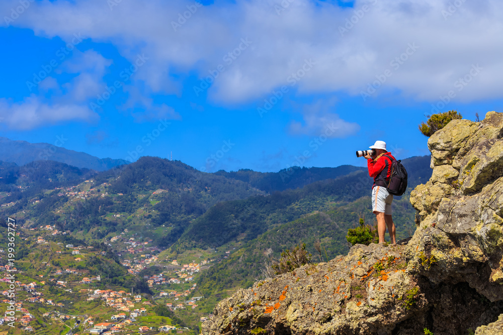 Man photographer shooting the landscape in Madeira mountain, Portugal