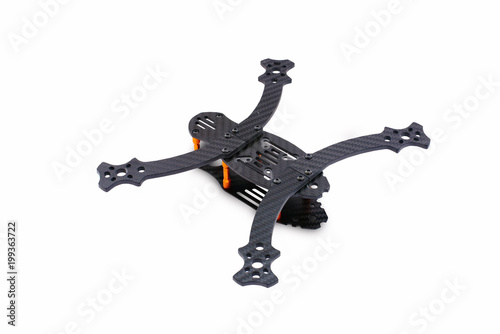The beginning of the racing drone assembly. A robust frame of an unmanned aerial vehicle made of carbon fiber. Frame of carbon fiber quadrocopter isolated on white background