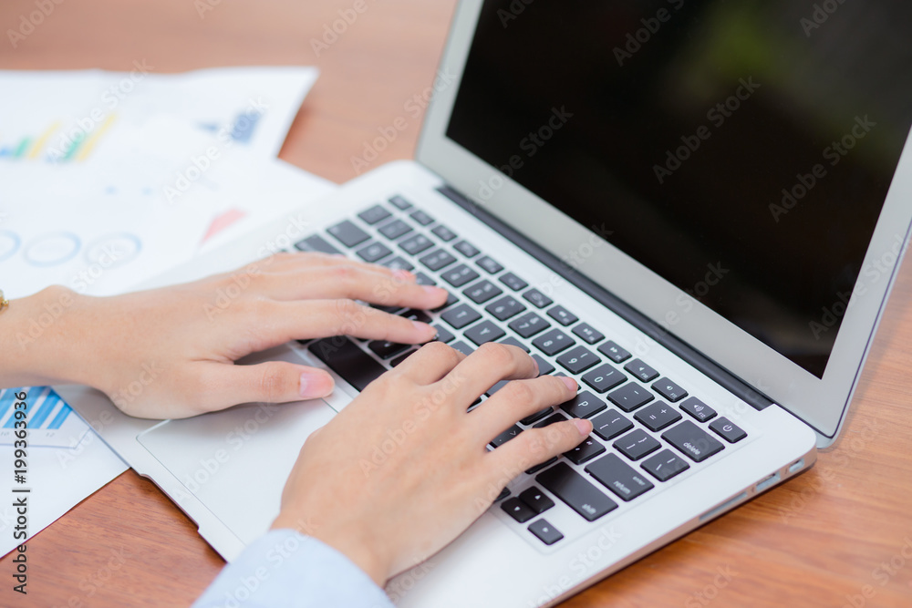 Closeup work with finance analysis and planing data on laptop, typing and paper graph with computer statistic for success, top view, business freelance concept. Closeup work with finance analysis and planing data on laptop, typing and paper graph with computer statistic for success, top view, business freelance concept.