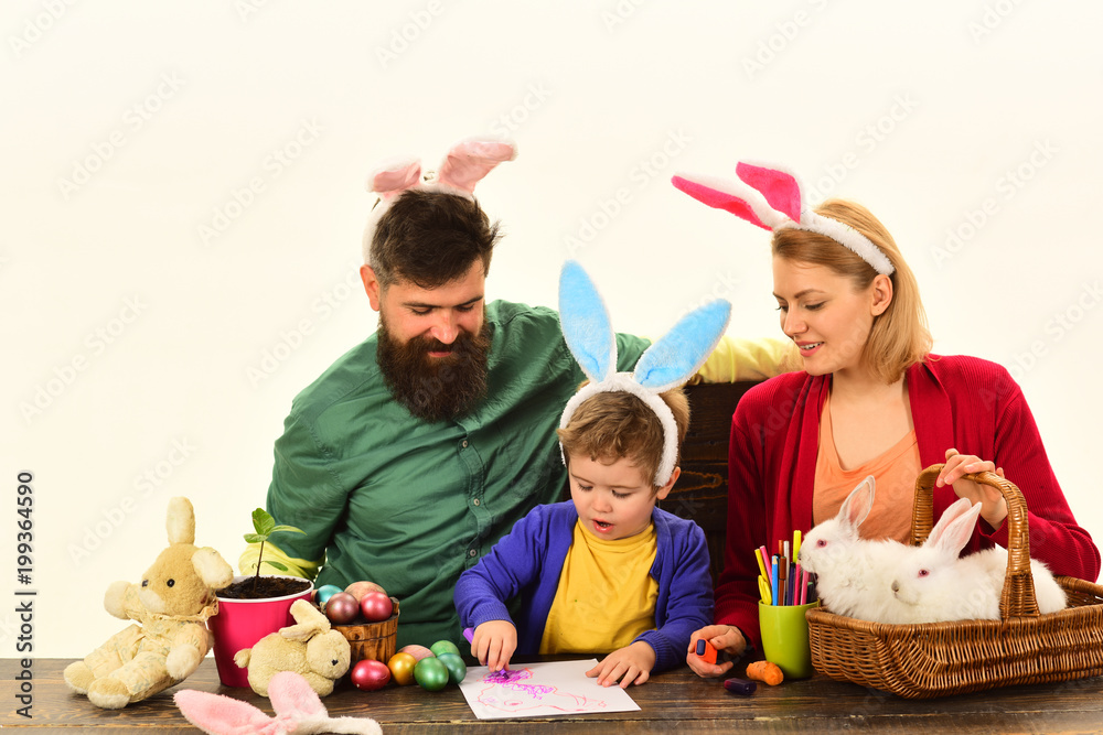 Mother, father and kid painting Easter eggs. Bunny ears and rabbit ears design. Mother, father and kid painting Easter eggs. Bunny ears and rabbit ears design.