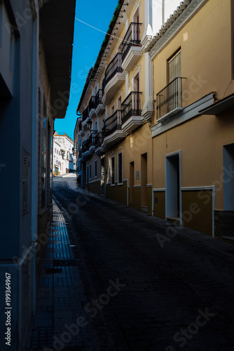 beautiful  picturesque street  narrow road  white facades of buildings  Spanish architecture