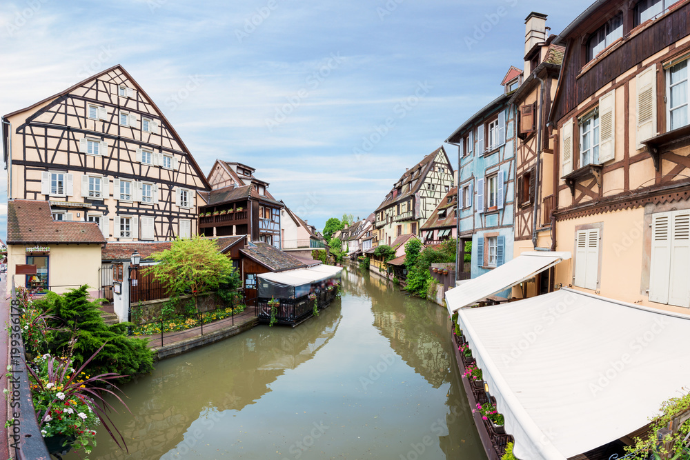 Colorful traditional french houses on the side of river Lauch in Petite Venise, Colmar, France.
