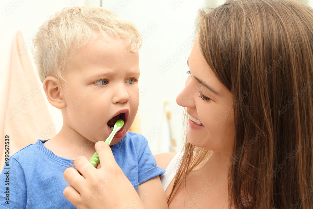 Mother teaching her child how to clean teeth Mother teaching her child how to clean teeth