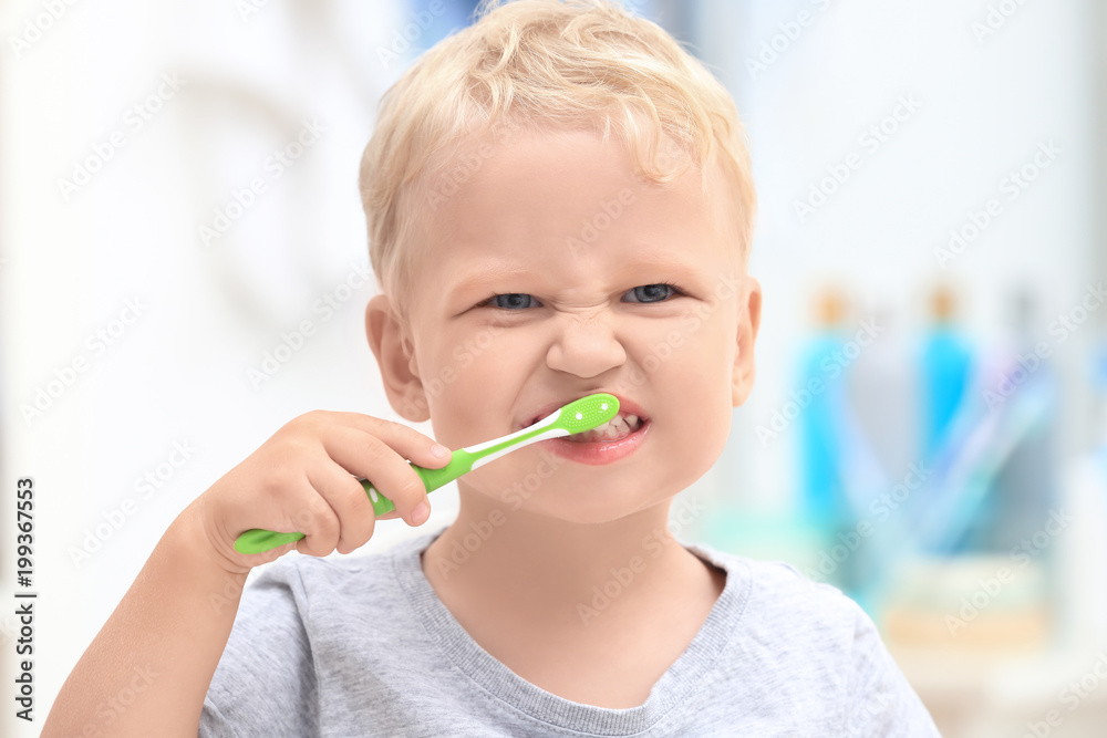 Cute little child cleaning teeth in bathroom Cute little child cleaning teeth in bathroom