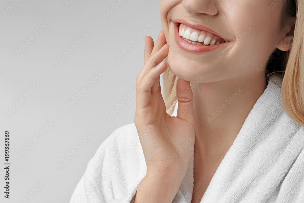 Young woman with silky skin on light background, closeup Young woman with silky skin on light background, closeup