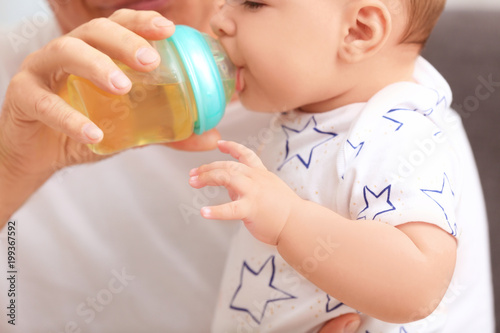 Senior man giving drink to ...