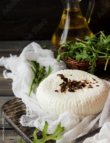 Soft Adyghe cheese with fresh rucola and dried tomatoes