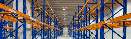 Wide image of empty shelves in logistics warehouse photo