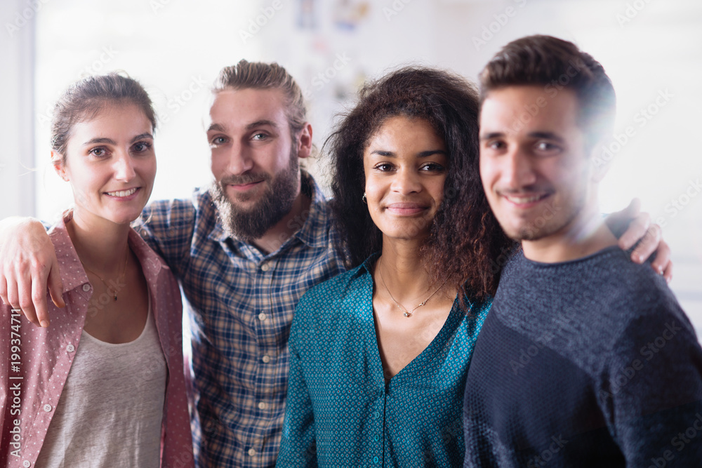A young multi-ethnic group of friends hugging each other. A young multi-ethnic group of friends hugging each other.