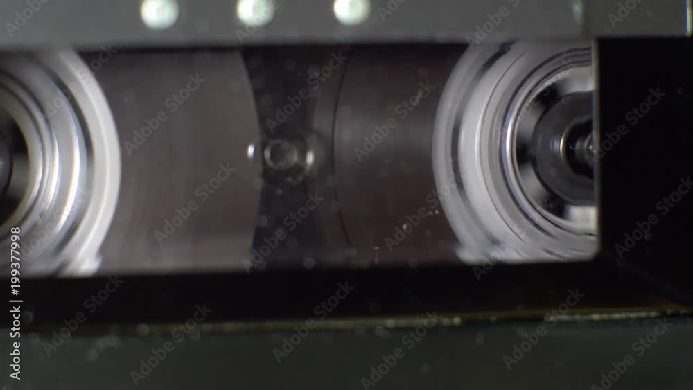 Close up of an audio cassette tape rewinding