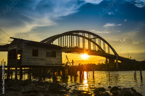 A beautiful sunset at the river near the bridge in Malaysia photo