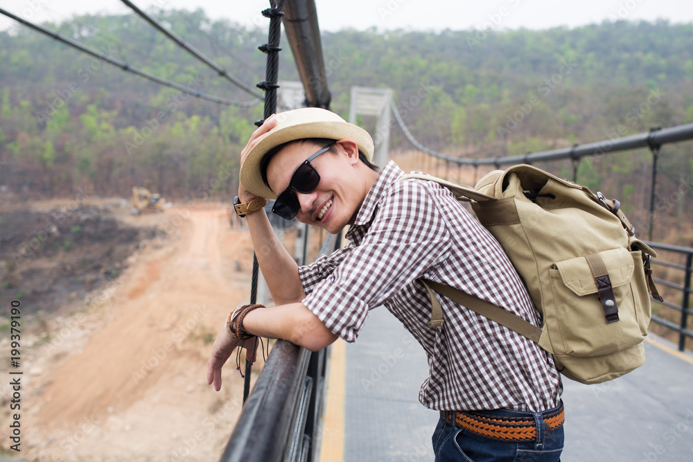 Young man traveller backpacker on rope bridge. Young man traveller backpacker on rope bridge.
