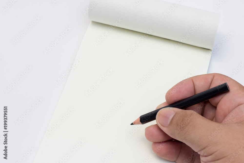 Hand hold a pencil on notebook paper Hand hold a pencil on notebook paper