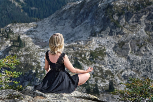 Young blond woman meditating in nature. Mount Seymour Provincial Park. Vancouver. British Columbia. Canada.