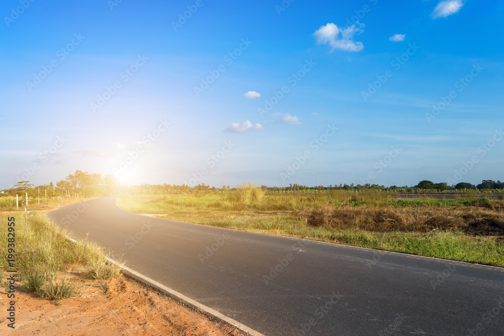 Rural roads Beside with nature and tree big green in fluffy clouds with blue sky background.