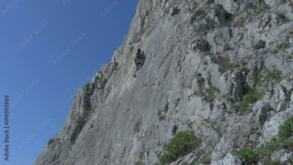 Man climbing on the wall of Piatra Secuiului Man climbing on the wall of Piatra Secuiului