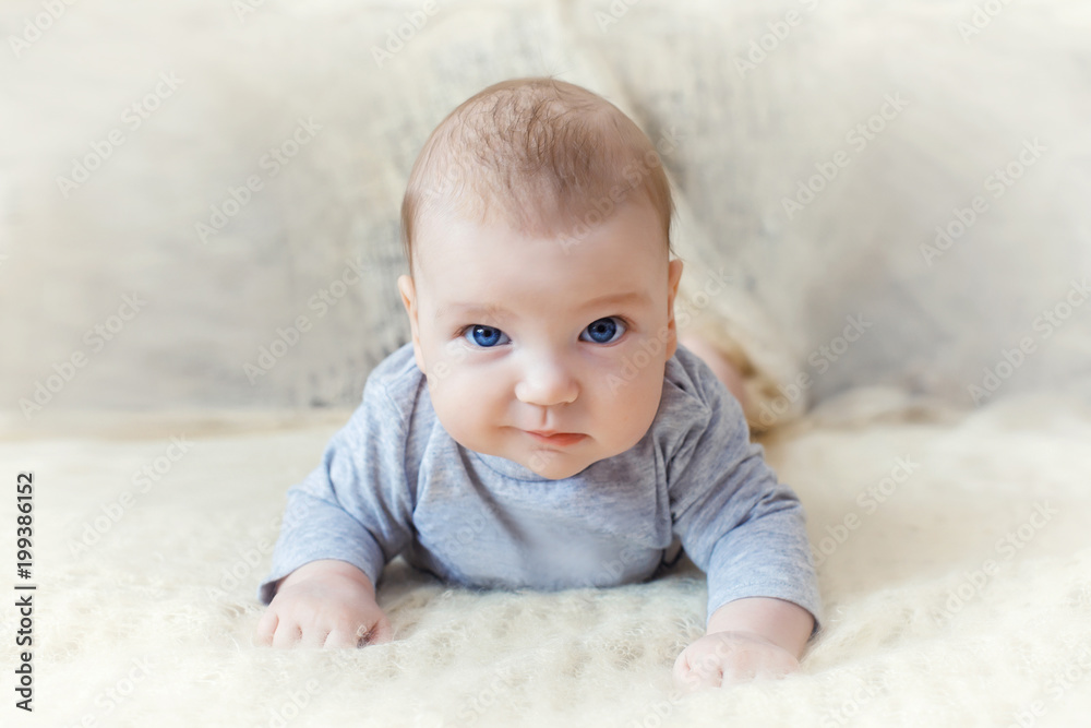 cute baby with blue eyes crawling forward cute baby with blue eyes crawling forward