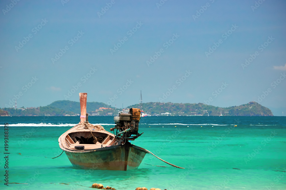 Beautiful seascape. Long Tail wooden boat in turquoise clear sea water. Tranquil waters, vacation wallpaper. Beautiful seascape. Long Tail wooden boat in turquoise clear sea water. Tranquil waters, vacation wallpaper.