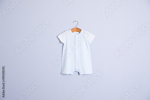 Baby clothes and accessories on wooden background photo