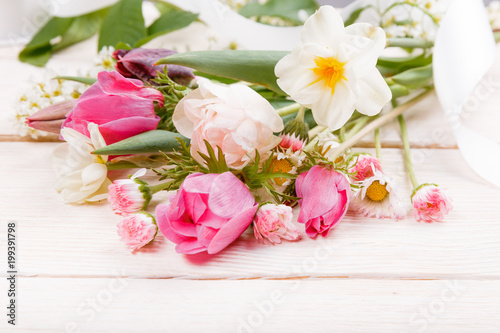 Festive flower pink  white anemones  tulips  daffodils  daisies composition on white wooden desk  background. Overhead top view  flat lay. Copy space. Birthday  Mother s  Women s  Wedding Day concept