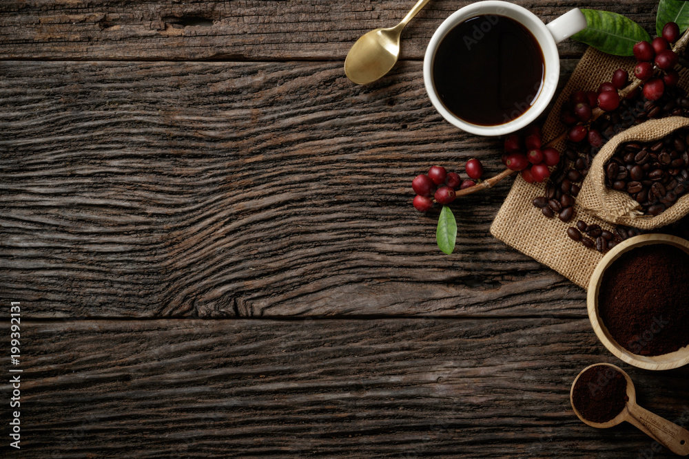 Top view mockup on wood background with a cup of coffee and red ripe coffee beans. Top view with copy space, flat lay. Top view mockup on wood background with a cup of coffee and red ripe coffee beans. Top view with copy space, flat lay.