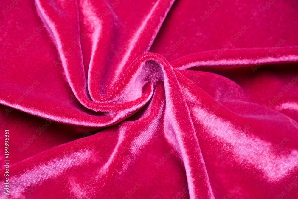 Obraz premium Background of fabric, twisted folds on red velvet.