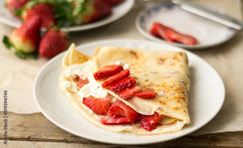 Homemade pancake with fresh ricotta cheese or whipped cream and strawberries Homemade pancake with fresh ricotta cheese or whipped cream and strawberries