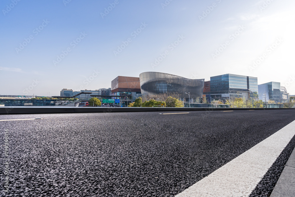 empty asphalt road with modern building empty asphalt road with modern building