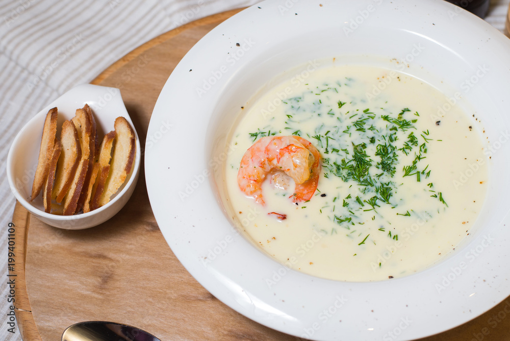 Soup Cream Shrimp on a White Plate on a Tree Soup Cream Shrimp on a White Plate on a Tree