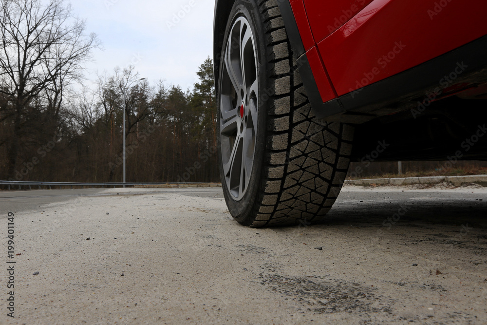 Sand on the tire tread of front wheel of the car on the road Sand on the tire tread of front wheel of the car on the road