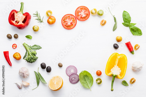 Various fresh vegetables and herbs on white background.Ingredients for cooking concept sweet basil  tomato  garlic  pepper and onion with flat lay..