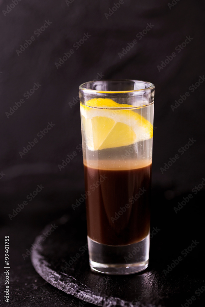 Alcoholic cocktail silver bullet with gin, coffee liqueur and lemon. Alcoholic cocktail silver bullet with gin, coffee liqueur and lemon.