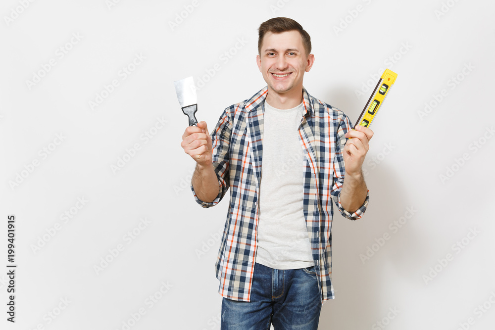 Young smiling handsome man in casual clothes holding putty knife and building bubble spirit level isolated on white background. Instruments for renovation apartment room. Repair home concept. Young smiling handsome man in casual clothes holding putty knife and building bubble spirit level isolated on white background. Instruments for renovation apartment room. Repair home concept.