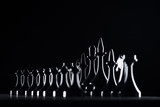 silhouettes of chess figures isolated on black, business concept