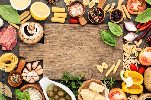 Wallpaper Mural Italian food cooking ingredients on dark stone background with cutting board flat lay and copy space. Torontodigital.ca