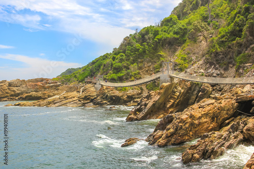 Suspended Bridges during trekking route over Storms River Mouth in Tsitsikamma National Park, Eastern Cape, near Plettenberg Bay in South Africa. Famous tourist destination along Garden Route.