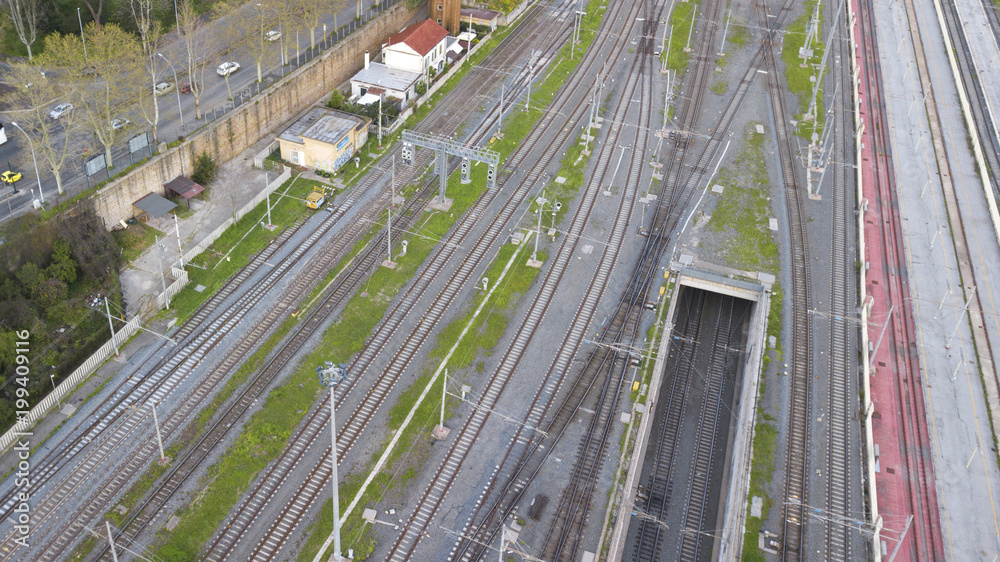 Aerial view of the tracks of a subway station without trains. Between the steel rails there are bushes of grass around white pebbles and pebbles. Aerial view of the tracks of a subway station without trains. Between the steel rails there are bushes of grass around white pebbles and pebbles.