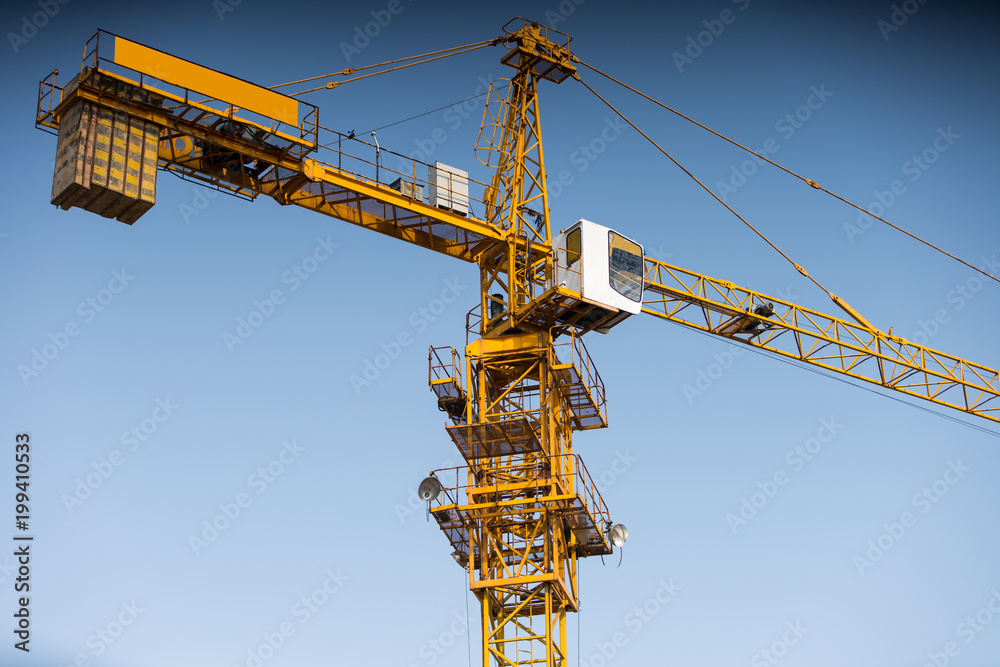 Construction crane tower against a blue sky Construction crane tower against a blue sky