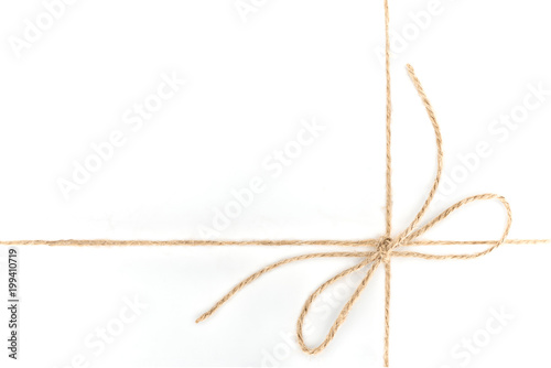 close up view of bow made of brown rope isolated on white